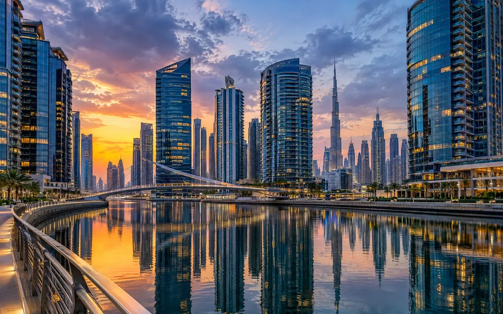 Business Bay towers reflected in the Dubai Water Canal at dusk (illustration)