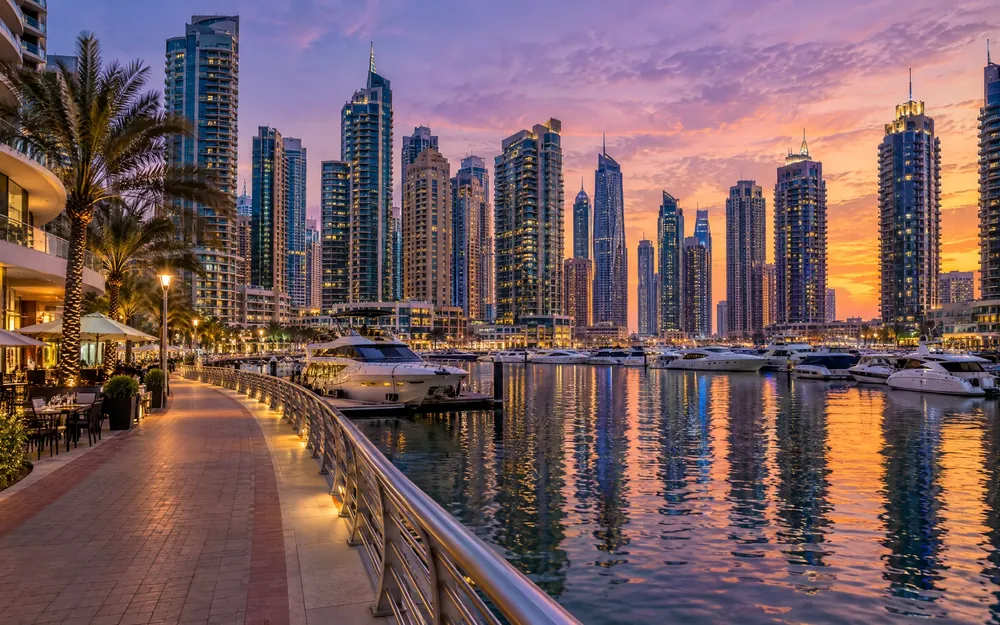 Dubai Marina promenade, yachts and towers at dusk (illustration)