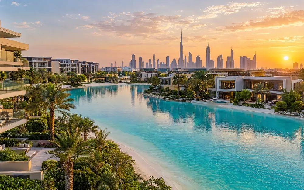 Lagoon-side residences in MBR City with the Downtown skyline behind (illustration)